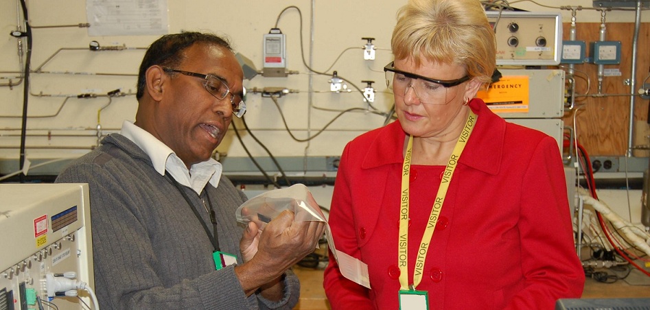 Sam Suppiah of AECL and Cheryl Gallant inspect a hydrogen fuel cell